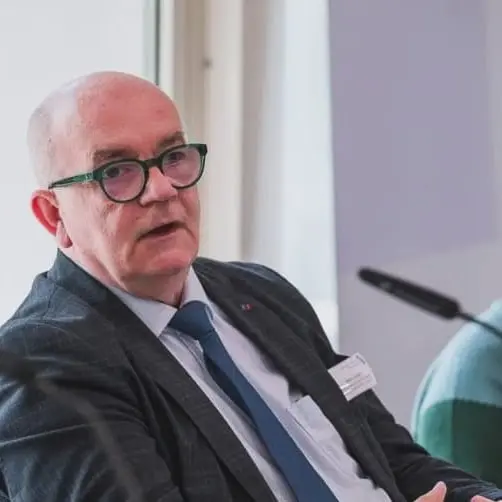 Detlef Zander sitzt vor dem Mikrofon und trägt eine schwarzen Anzug.